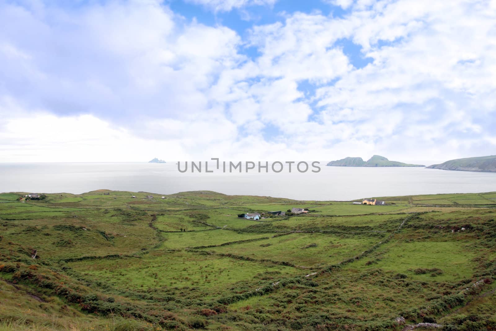 scenic view in kerry ireland of fields coastline and skellig rock