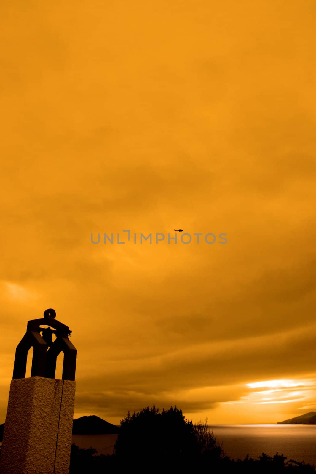 bell tower at sunset with scenic view in kerry ireland of coastline