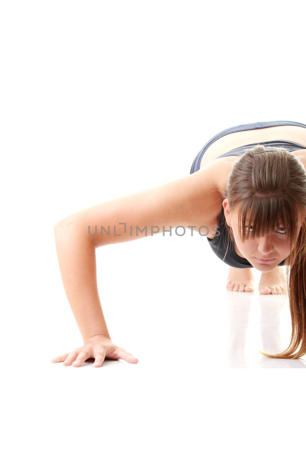 Relaxed fit woman doing exercise, isolated on white background.