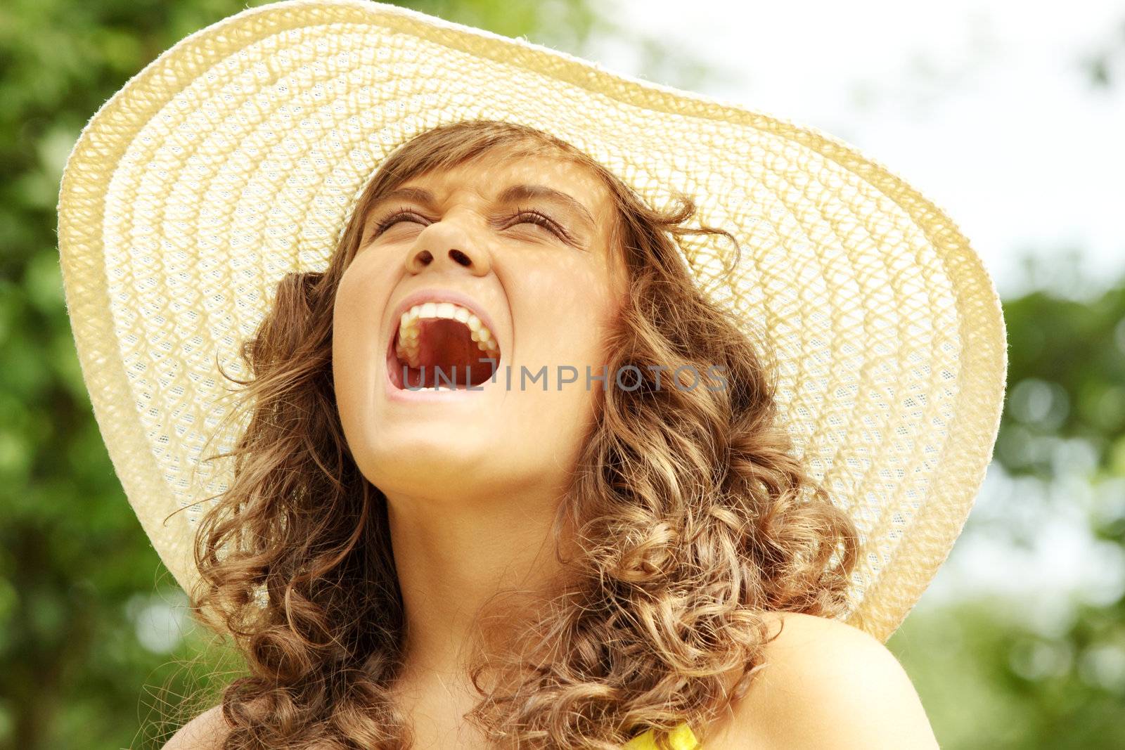 Young woman screaming in country side