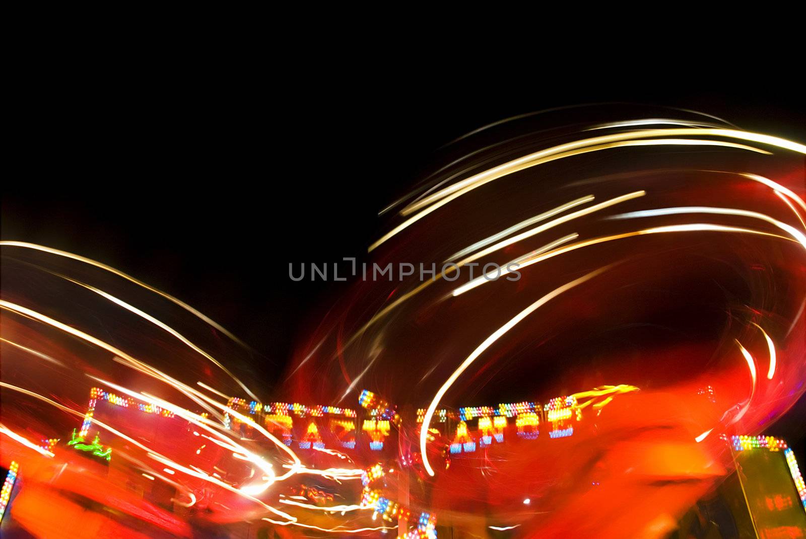 Blur neon lights in amusement park, long exposure