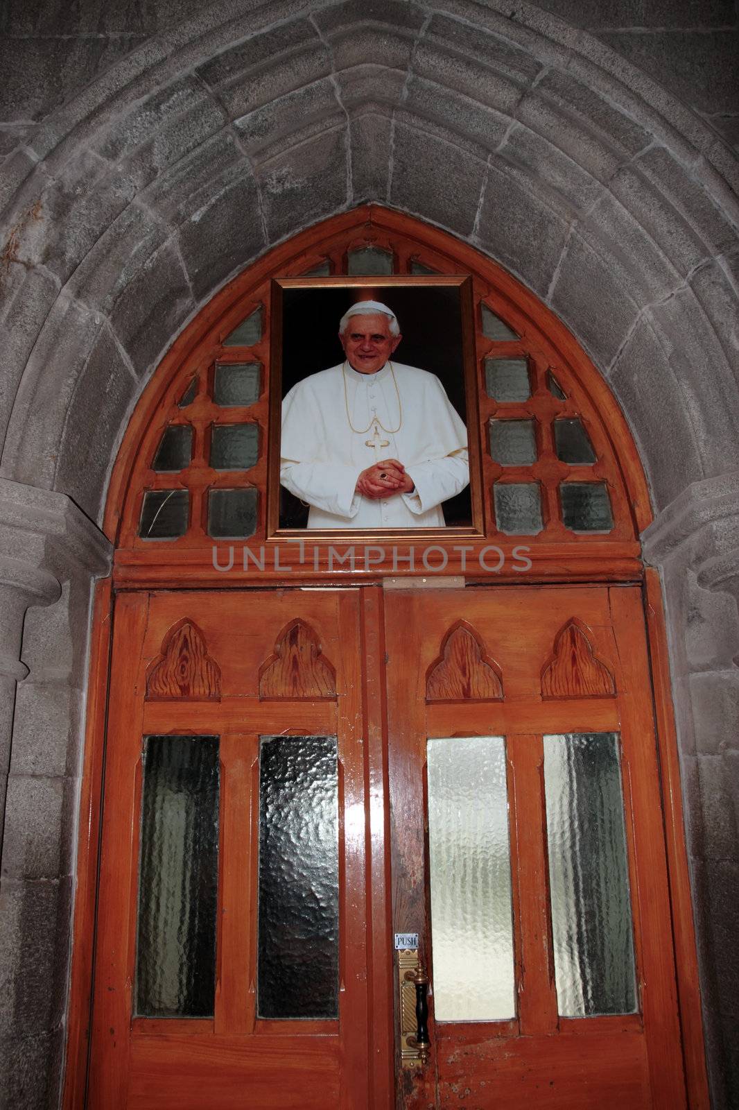 the interior door of an irish church with painting of pope