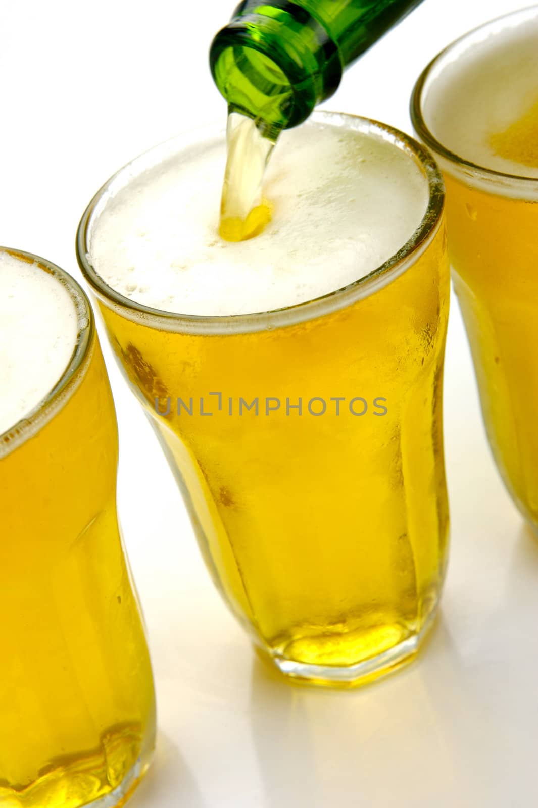 Glasses of beer isolated against a white background