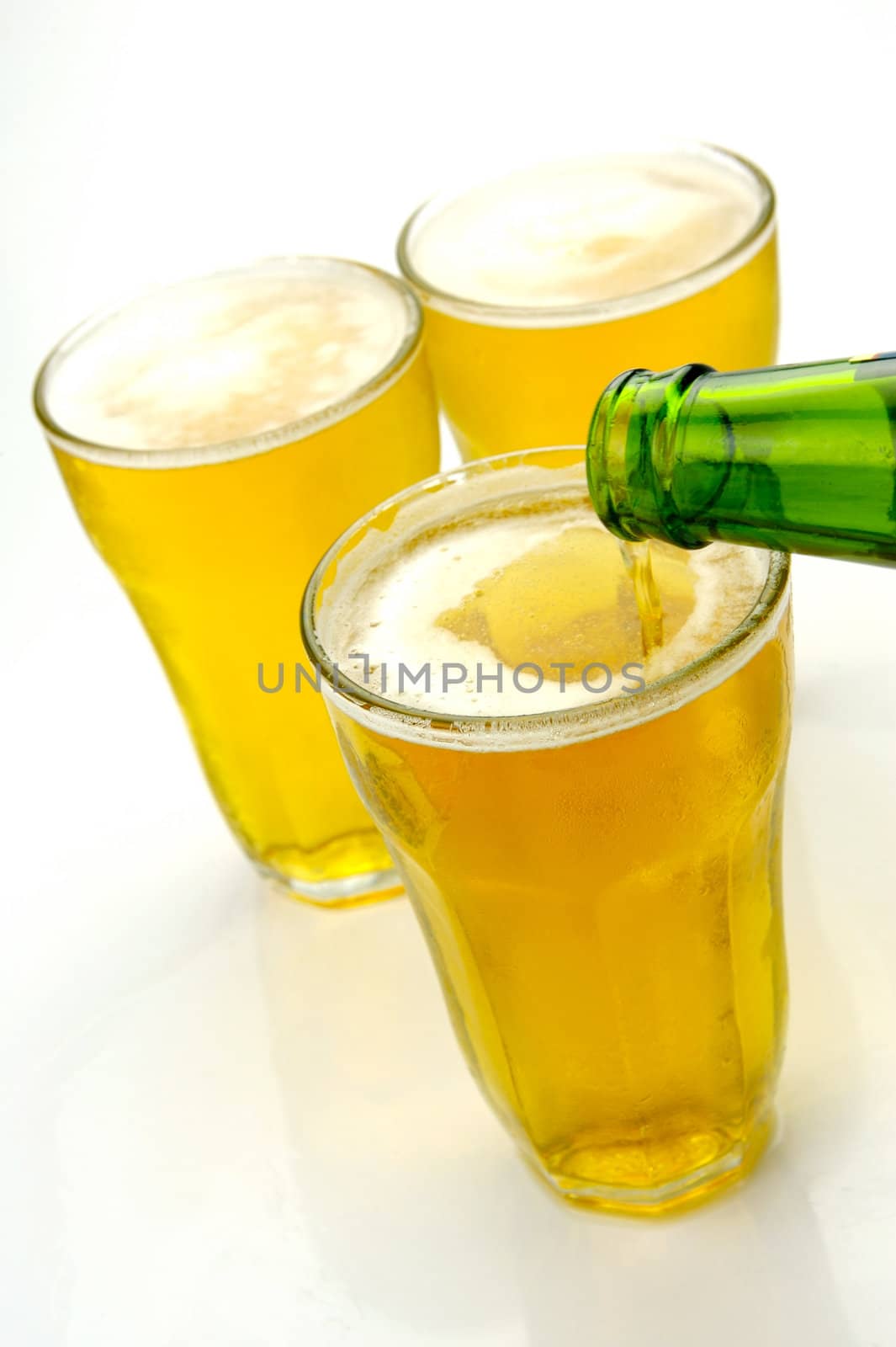 Glasses of beer isolated against a white background