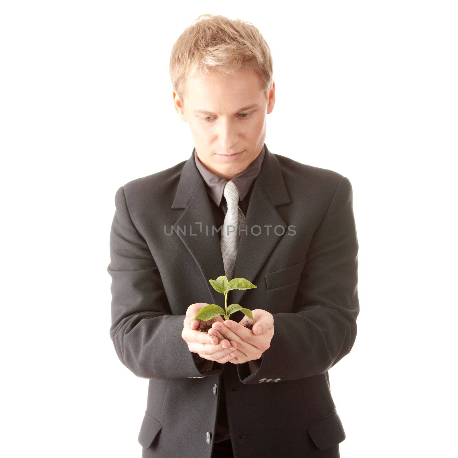 Man in suit holding smal plant in his hands by BDS