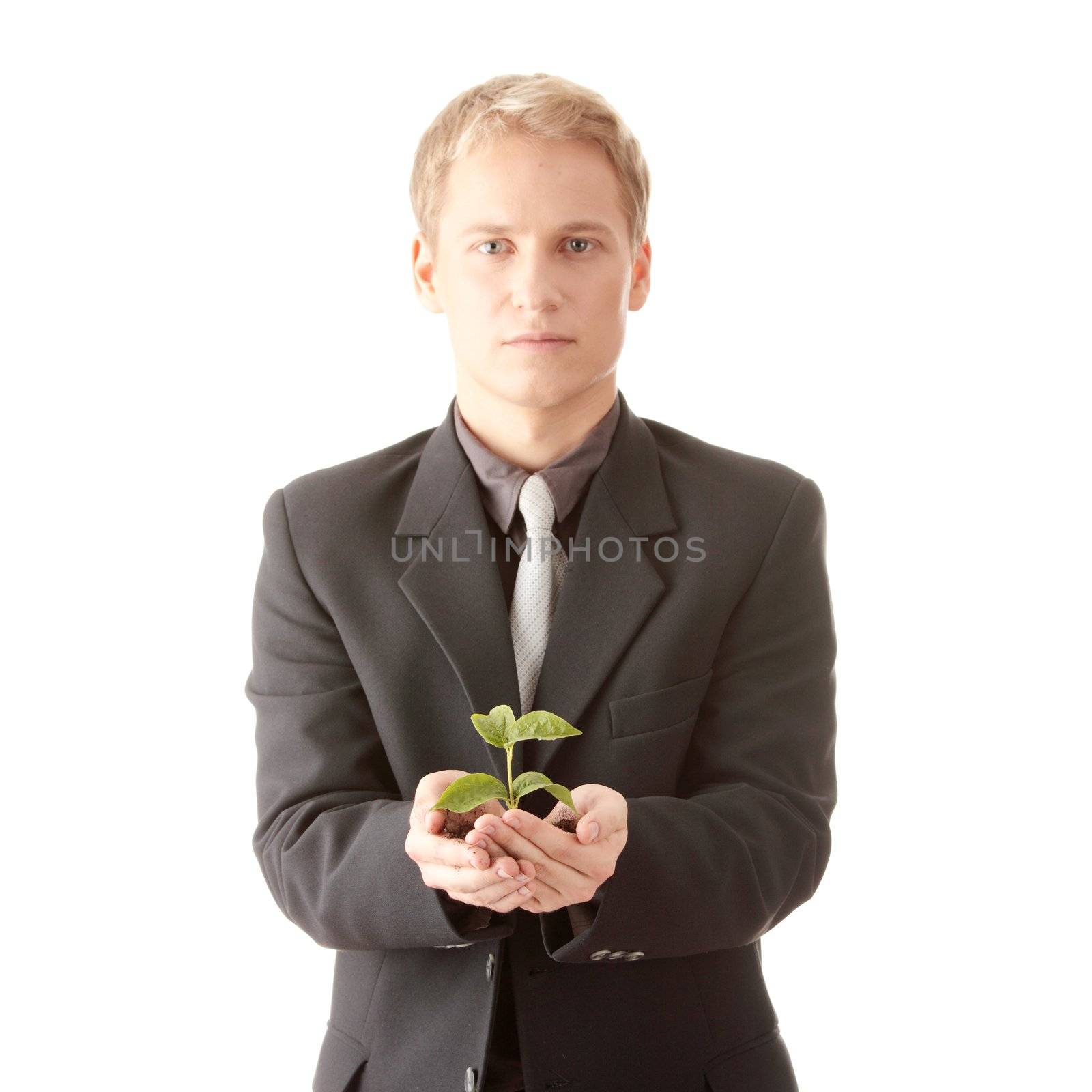 Man in suit holding smal plant in his hands by BDS