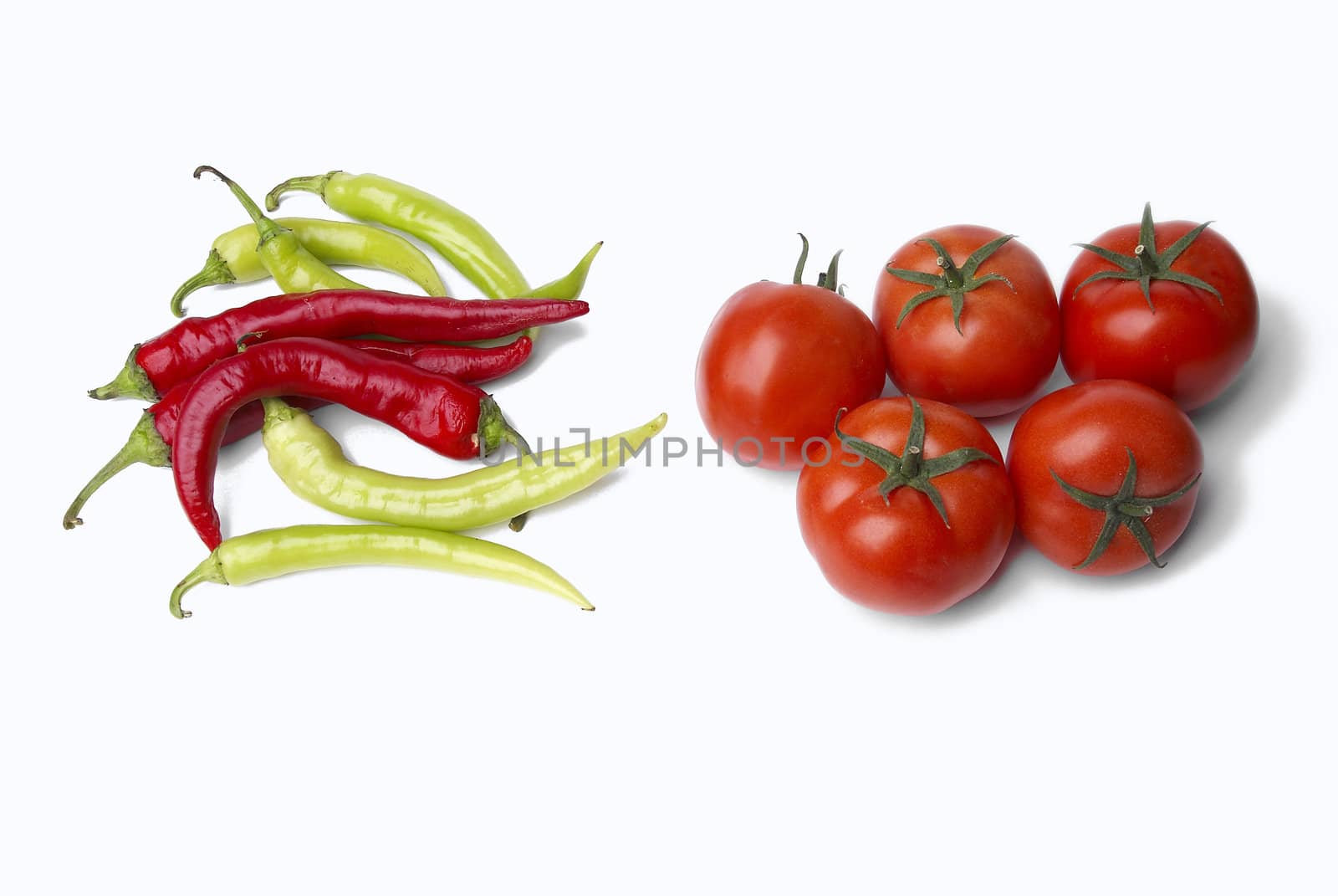 Peppers and tomatoes on white background