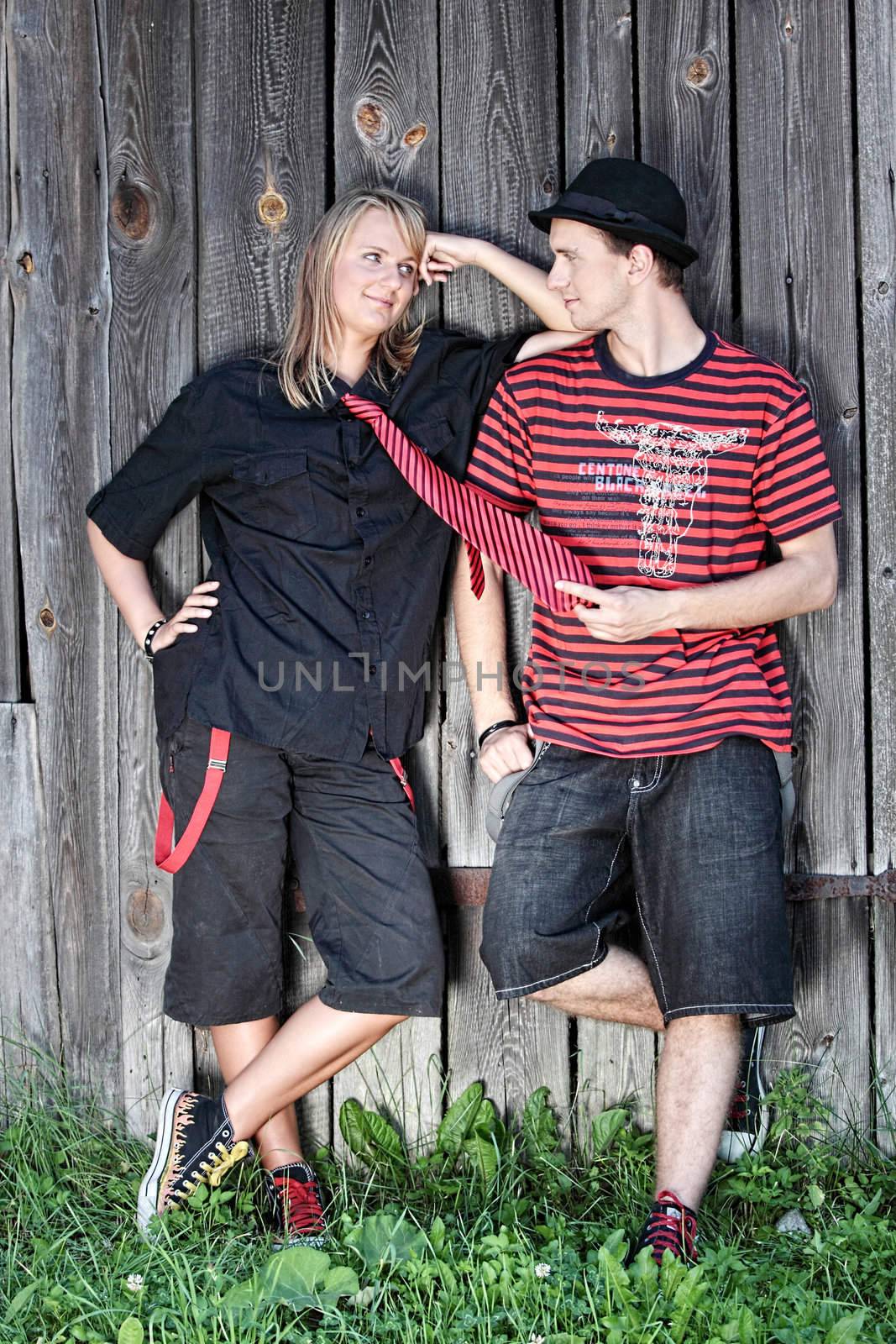 Punk couple against wood wall - street fashion