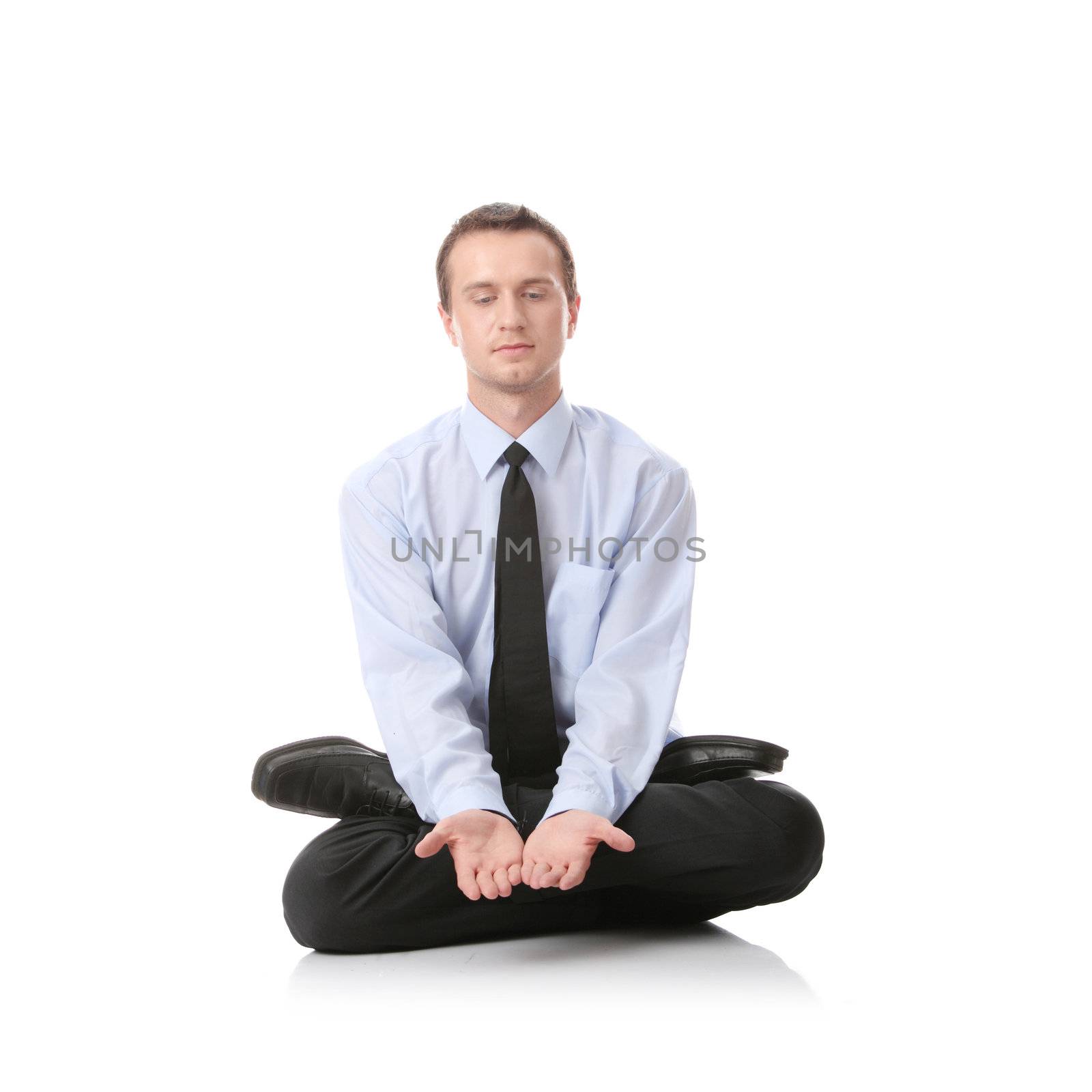 Businessman sitting in lotus position, Isolated against white background