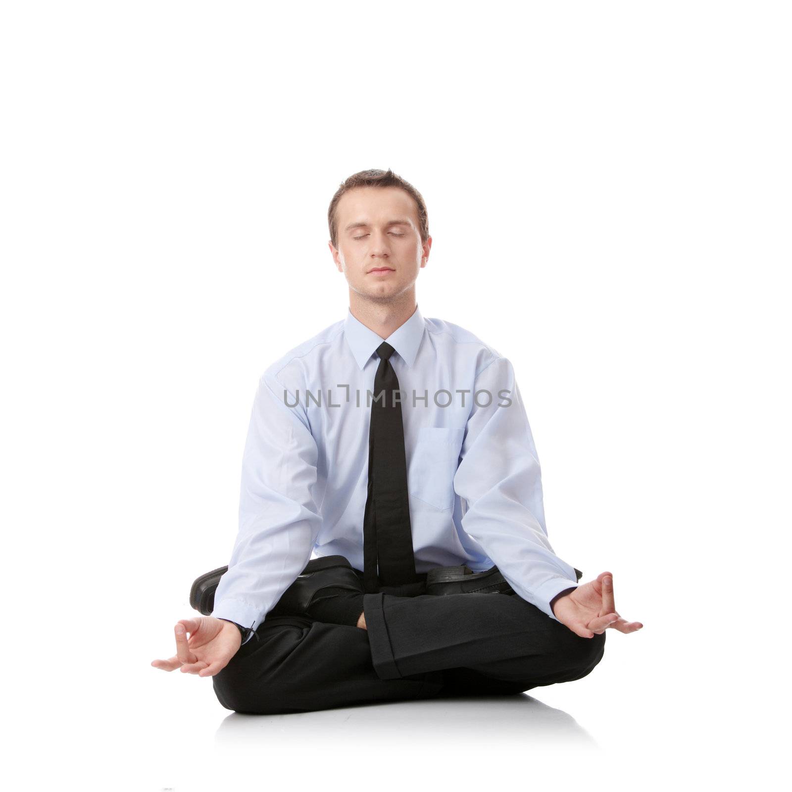 Businessman sitting in lotus position, Isolated against white background