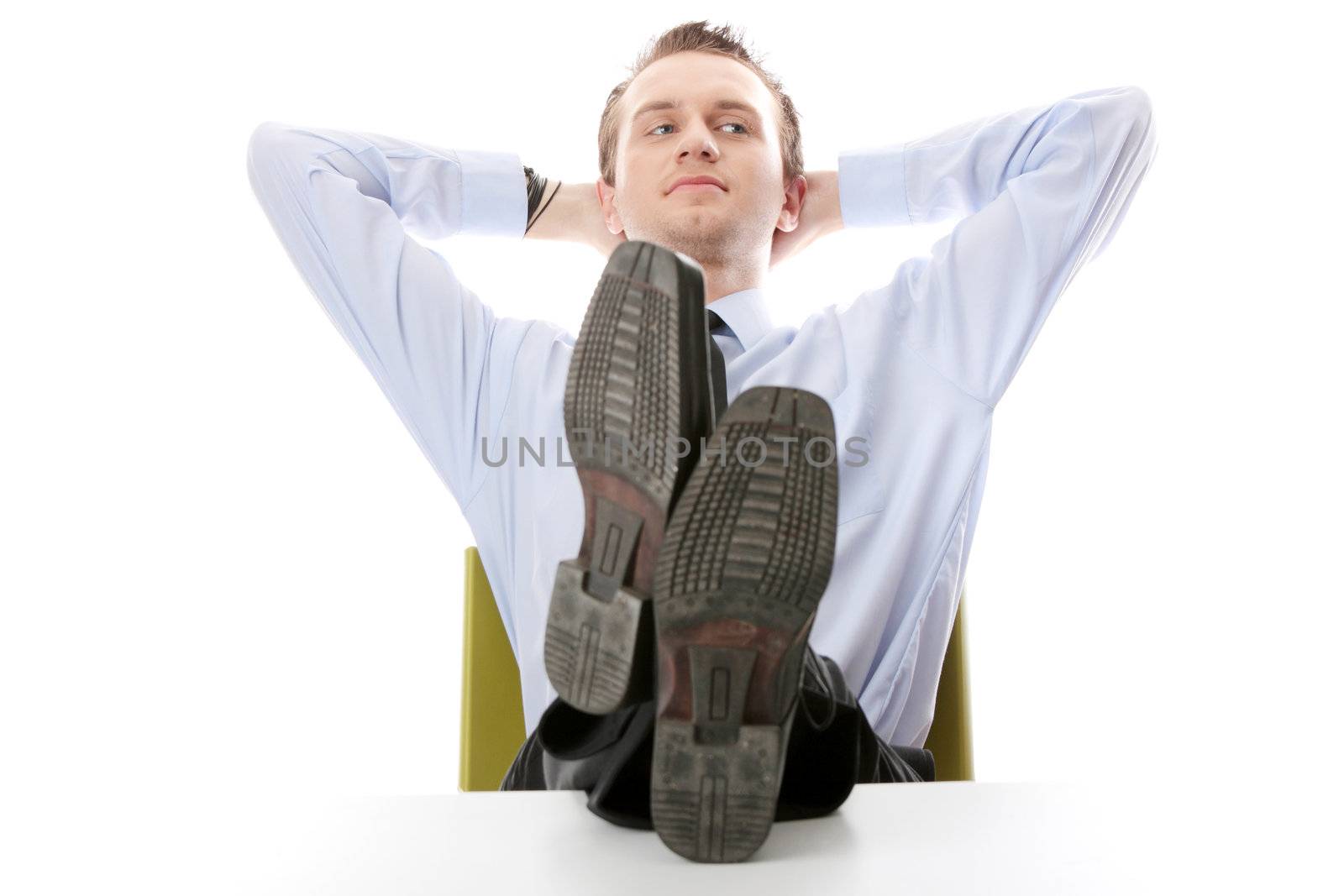 Businessman sitting at desk, isolated