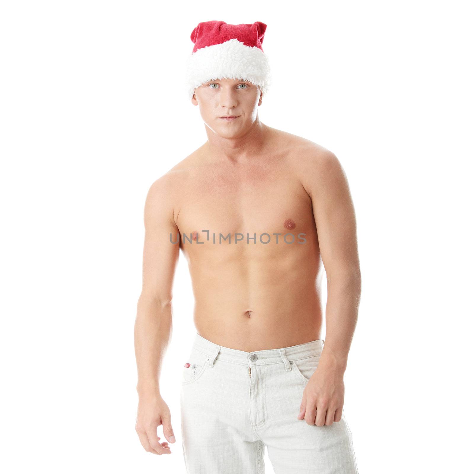 Sexy muscular man wearing a Santa Claus hat isolated on white