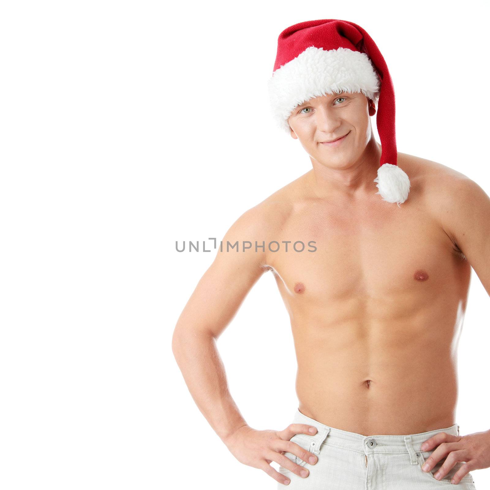 Sexy muscular man wearing a Santa Claus hat isolated on white