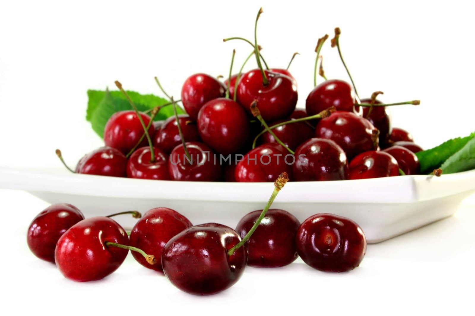 fresh red cherries on a white background