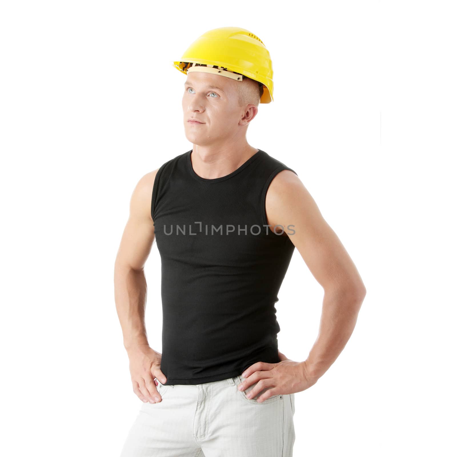 Young handsome builder in yellow helmet. by BDS