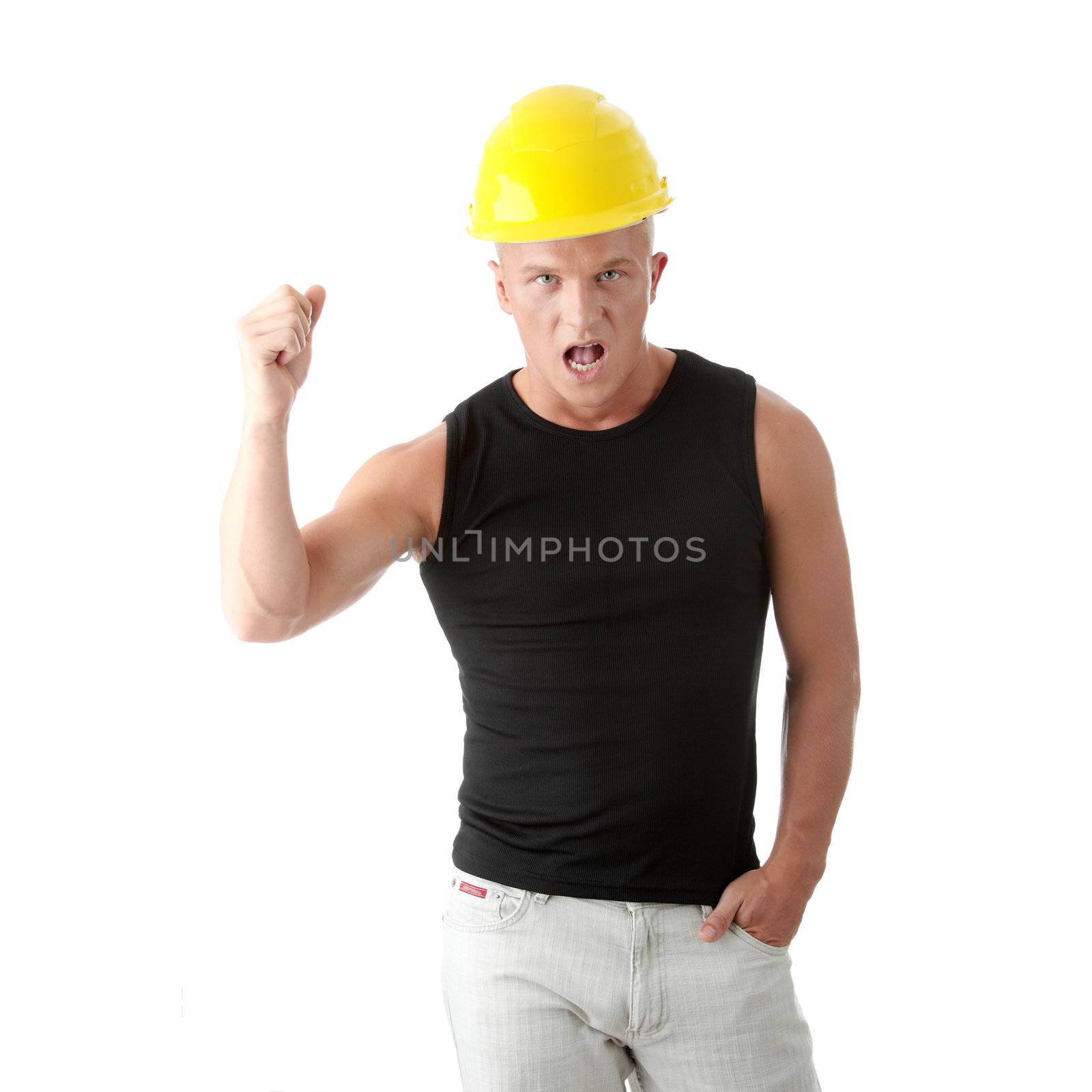 Young handsome angry builder in yellow helmet. Isolated over white background