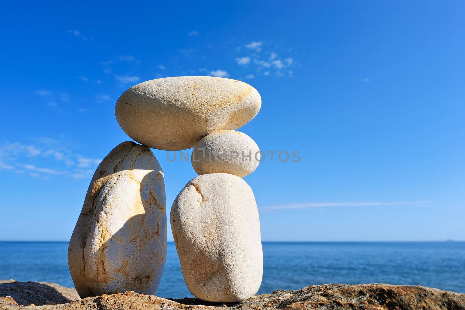 Pebble in balance between the two long boulders