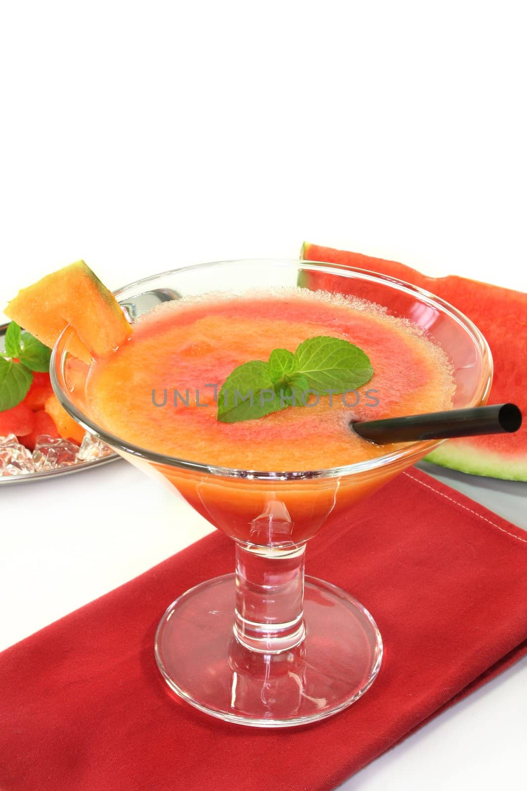 a glass of melon smoothie with fresh mint