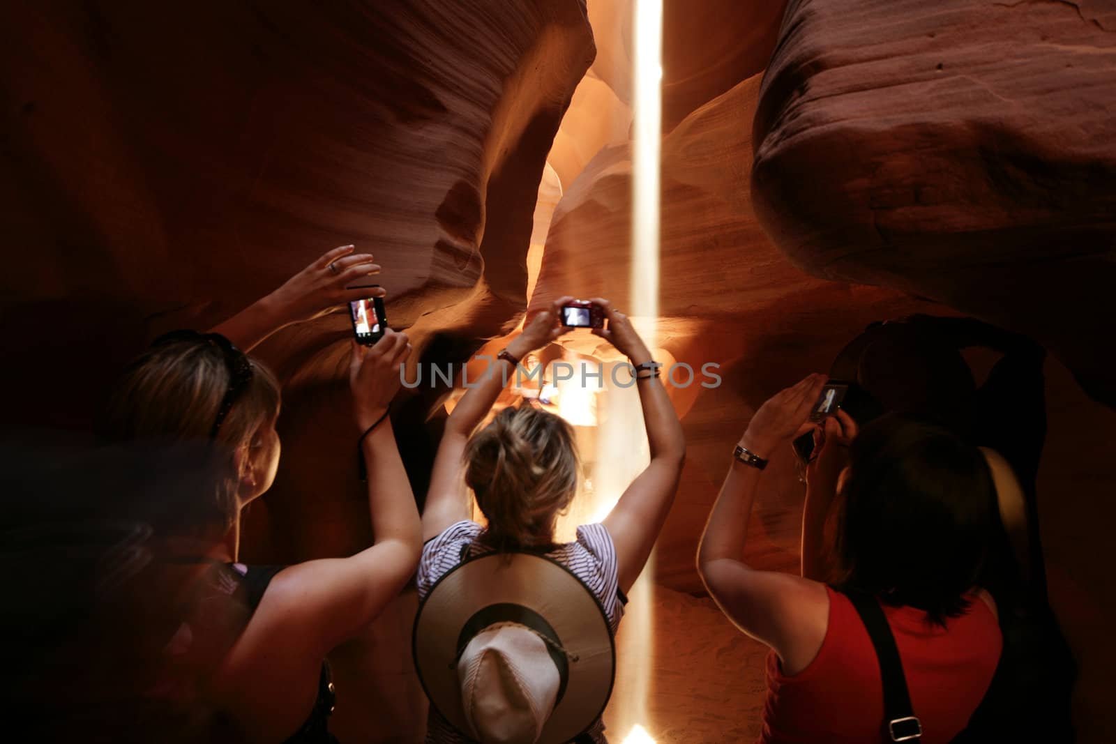 people taking pictures at the upper antelope canyon