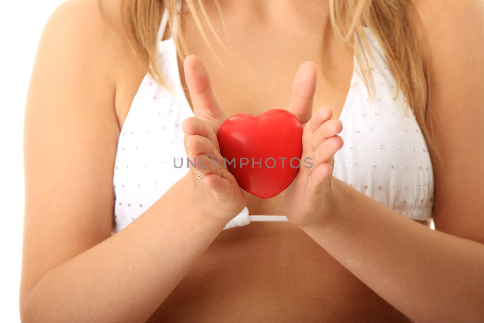 Young woman in bikini holding heart in her hands