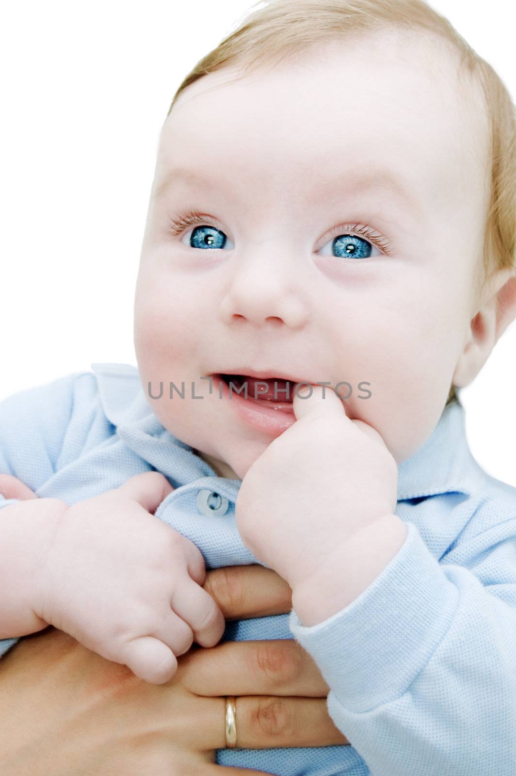 Adorable curious boy with finger in mouth