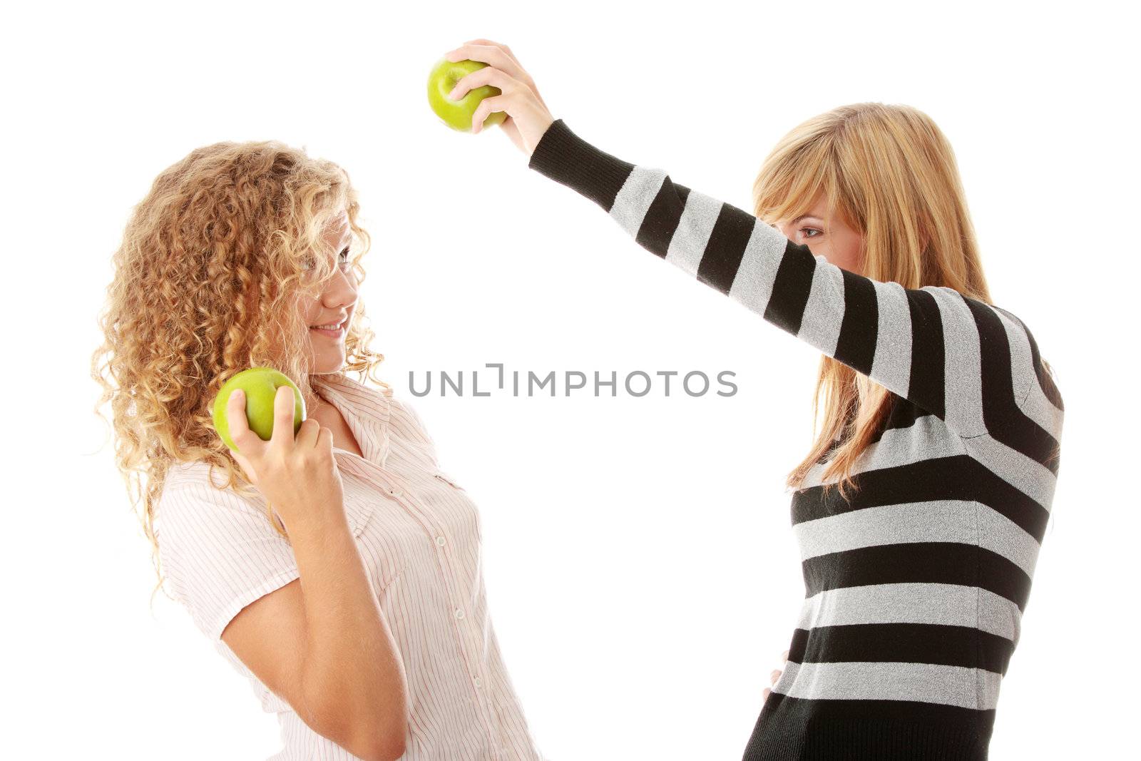 Two teen girlfriends eating green apples isolated