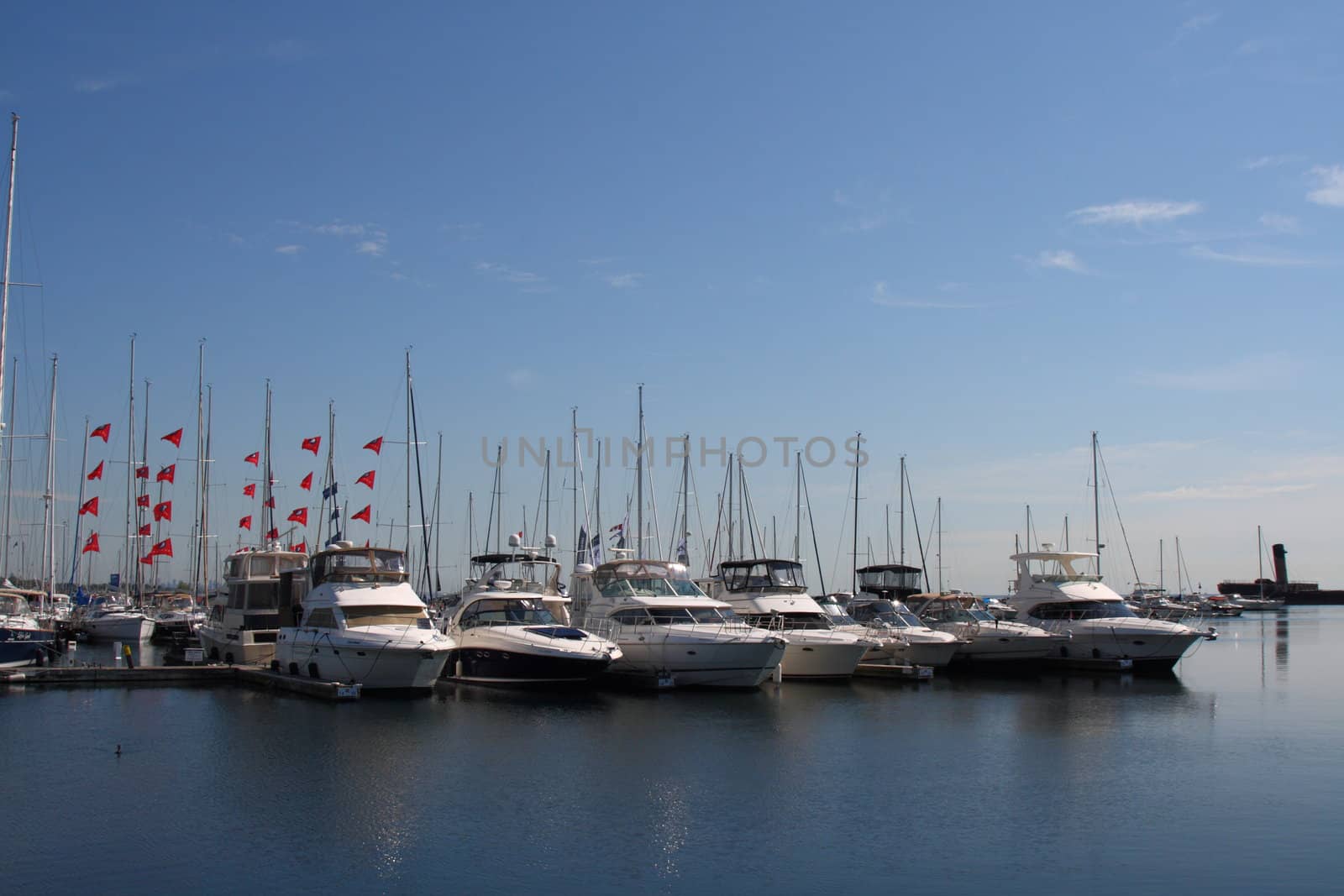 boats and yahts docked in a marina by lake