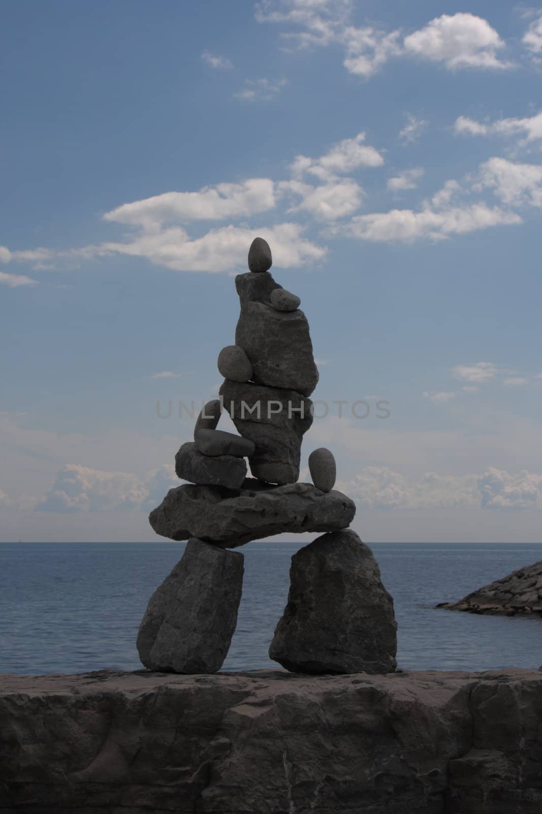 solitary inukshuk art statue by the lake