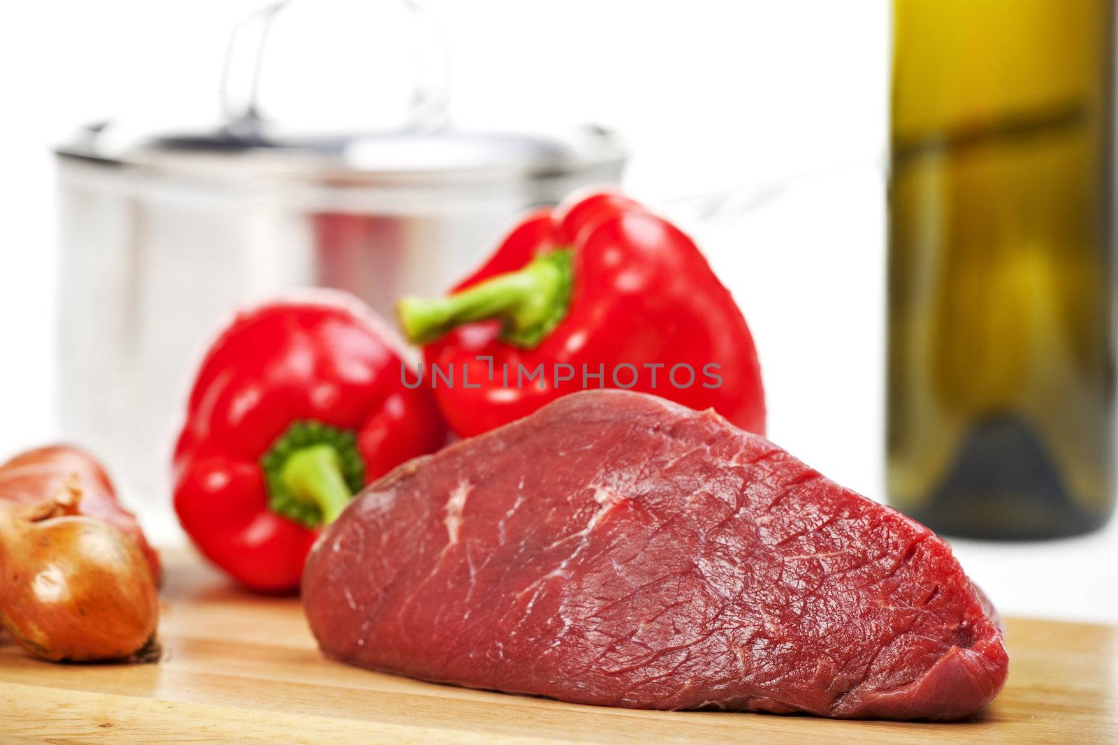 raw meat on a wooden chopping board by bernjuer