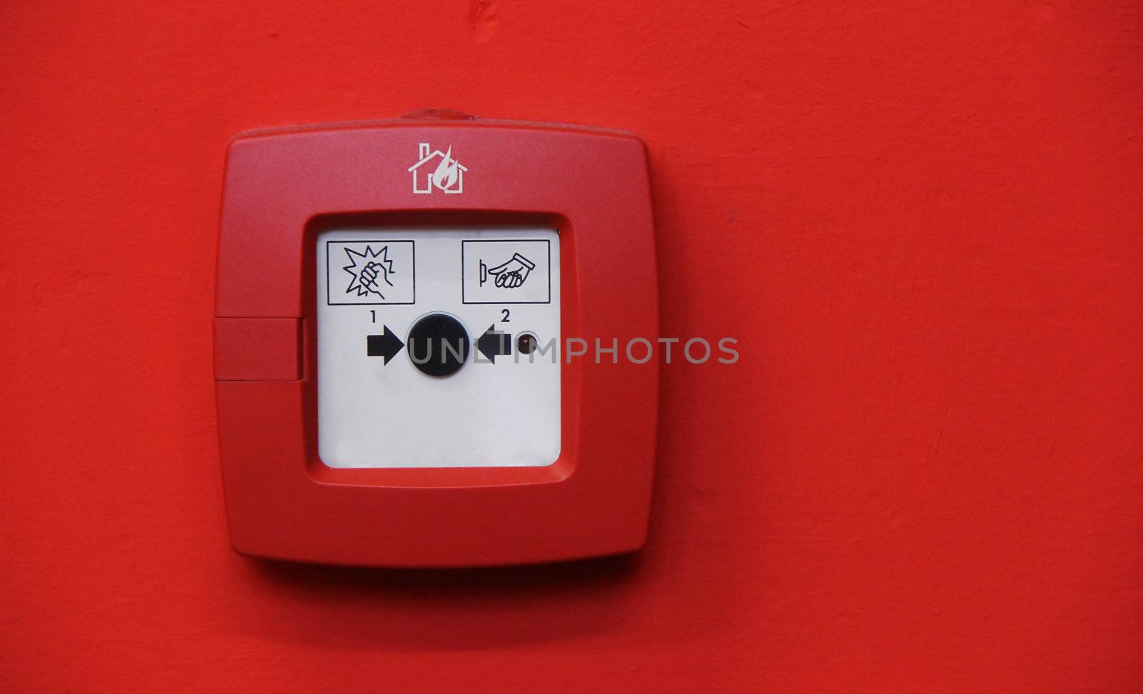 fire alarm system button on red wall