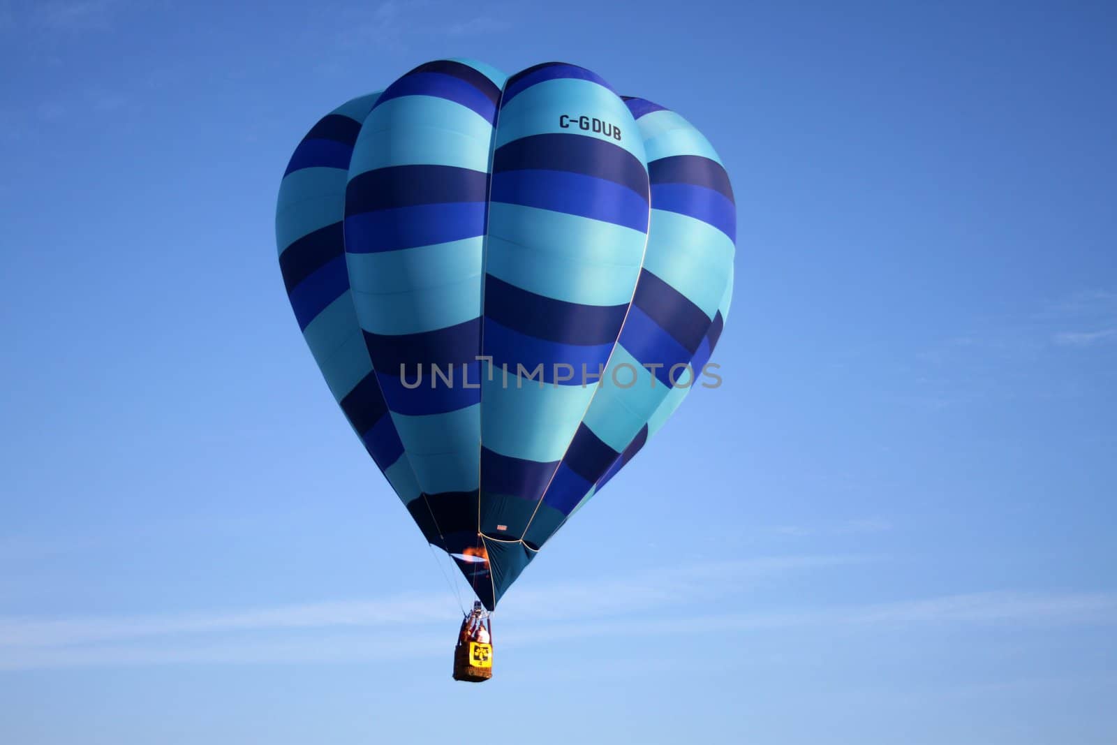 Striped blue hot air balloon on blue sky background