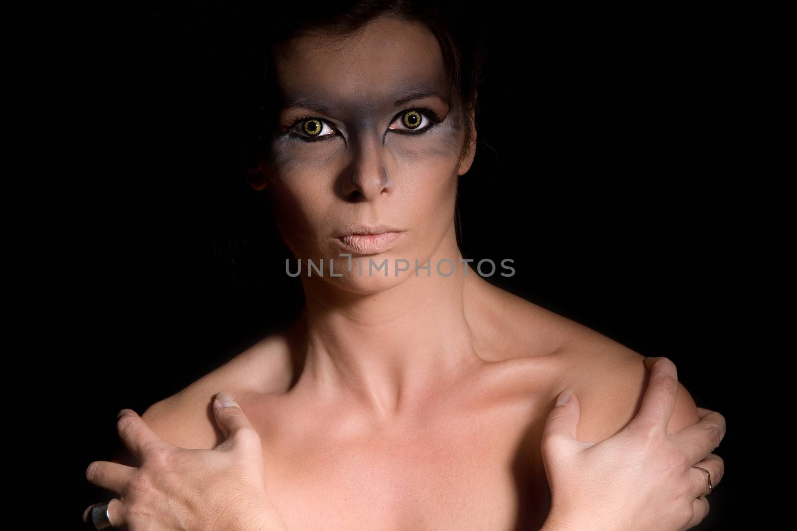 Beautiful woman with scary eyes on black background