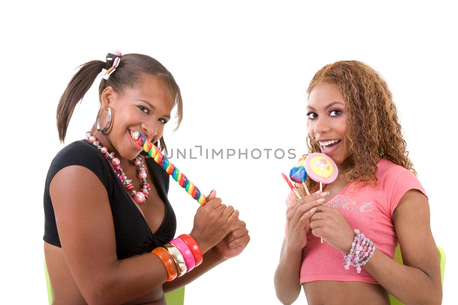 Two black girls sitting together and eating a lollipop