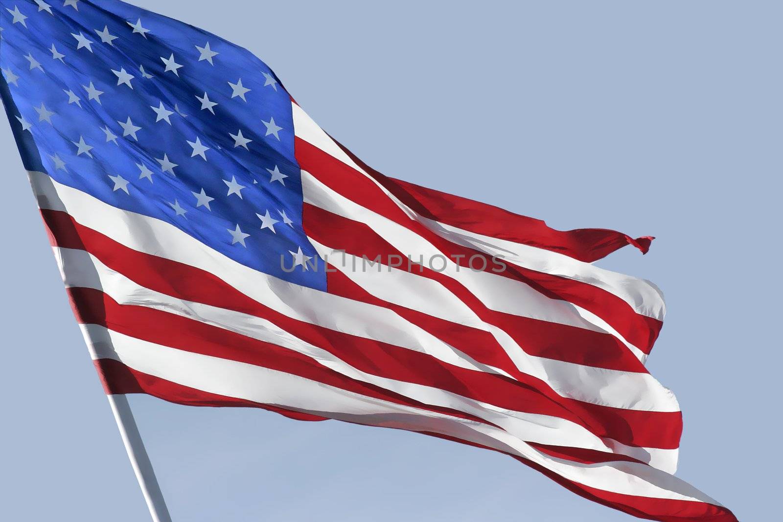 Beautiful USA Flag waving in the wind with bright natural sunlight shinning through the back illuminating the flag