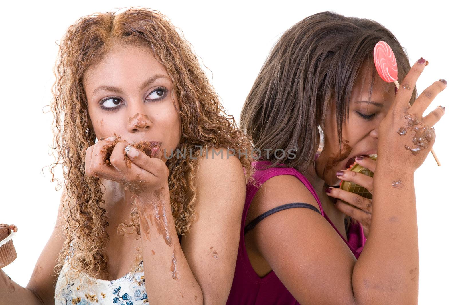 Two attractive women sitting back to back and eating too much