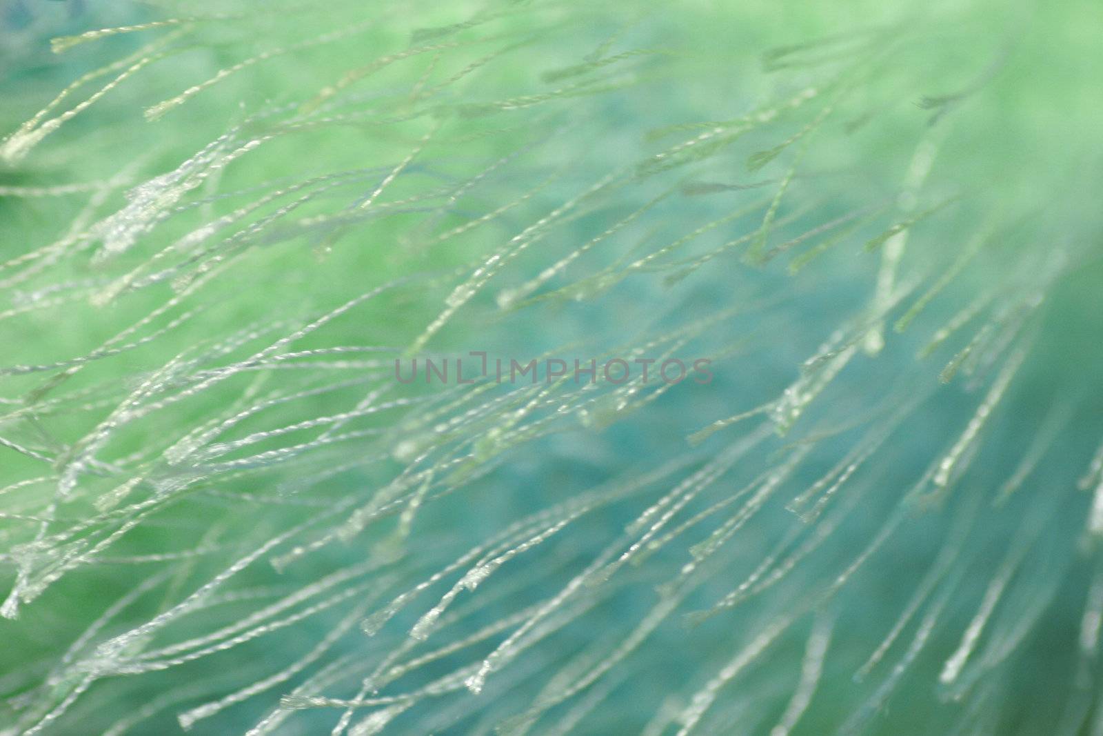 Extreme closeup of textured carpet fibers material in an abstract pattern