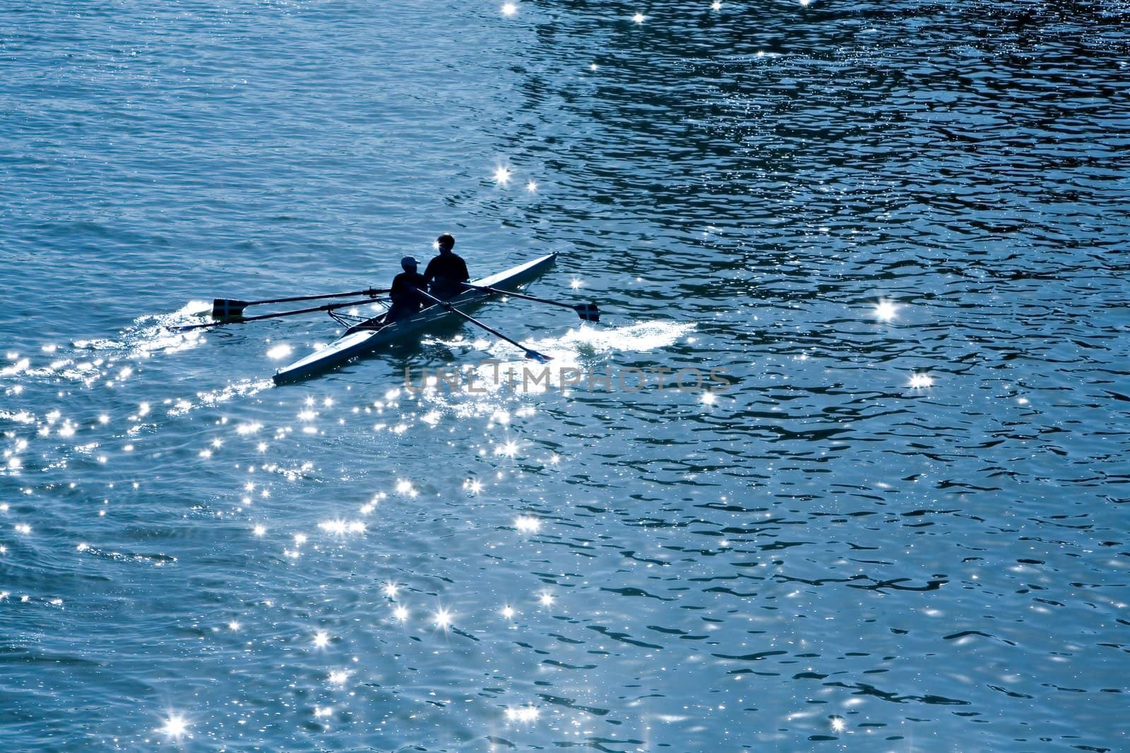 Two persons with oars in a kayak in the sea in a sunny day 
