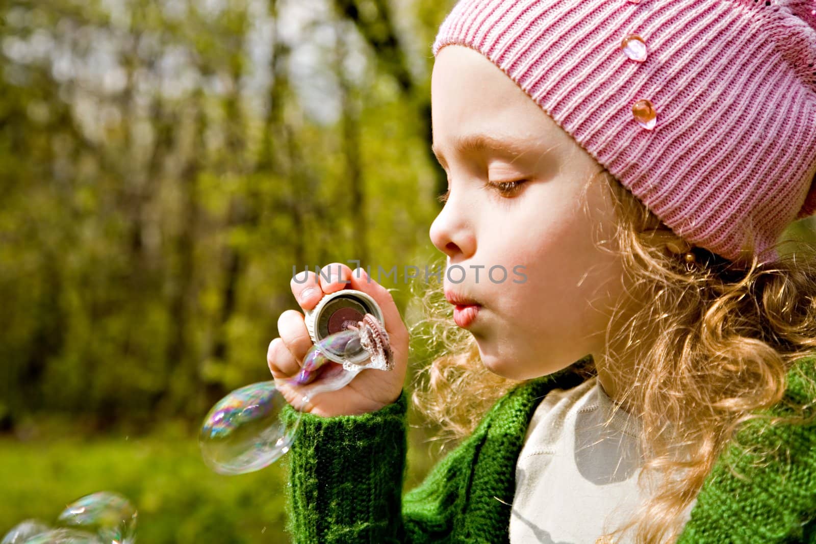 Portrait of the girl with soap bubbles in forest by Gravicapa