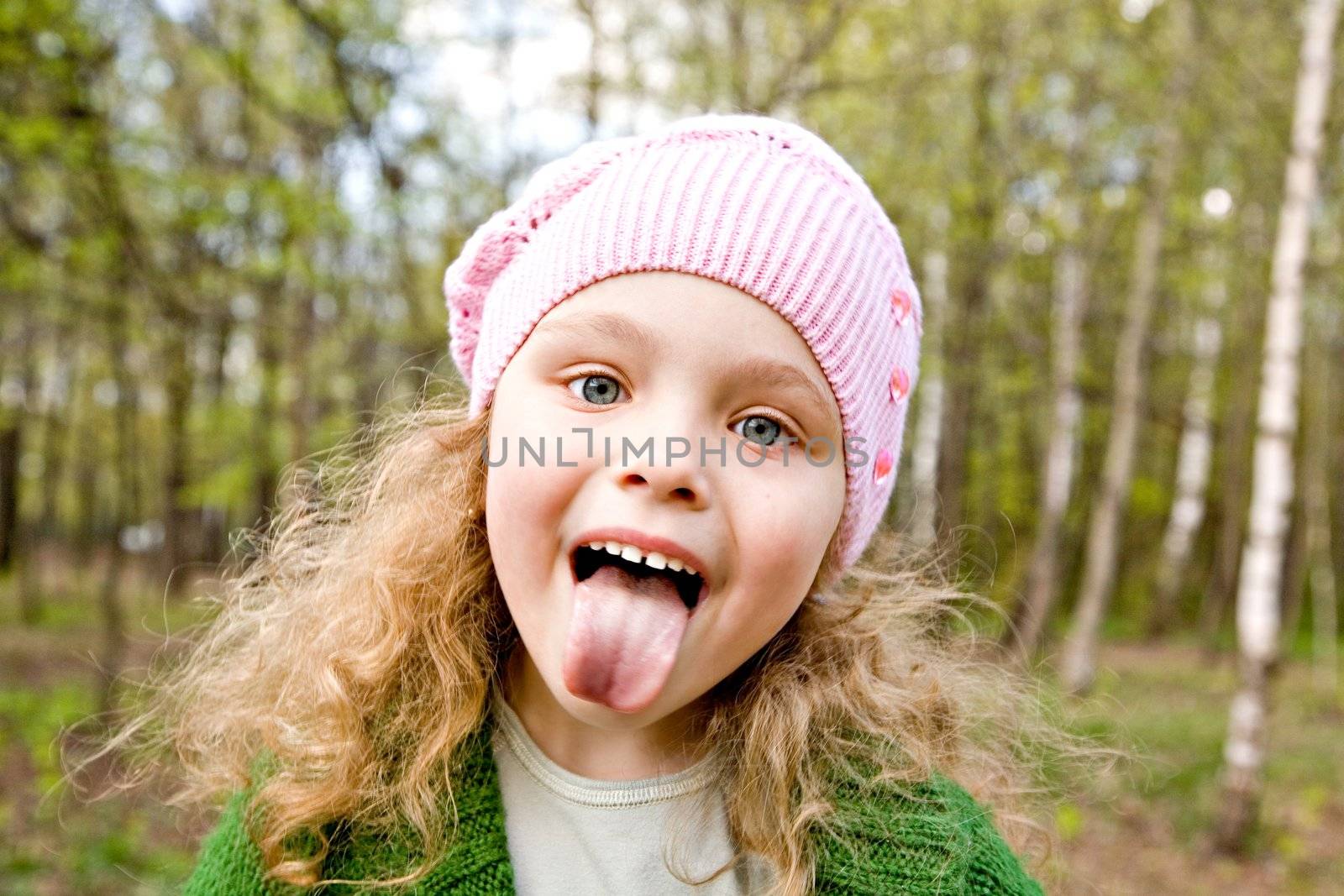 Cheerful girl puts out the tongue by Gravicapa