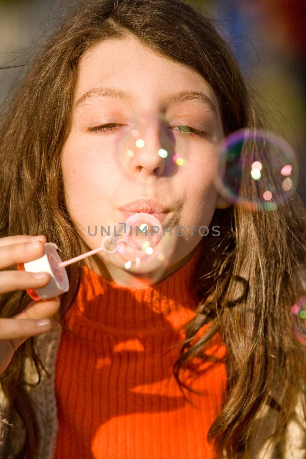 The young girl inflates soap bubbles
