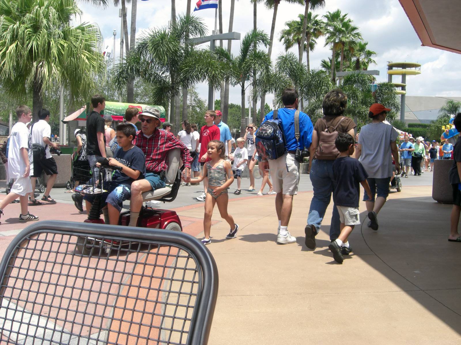Crowds of people are milling around at a theme park in Orlando Florida