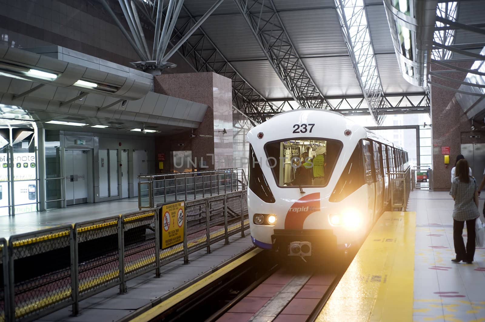 Kuala Lumpur , Malaysia - March 16, 2011: Kuala Lumpur LRT train arriving on train station. Kuala Lumpur's metro or rapid transit system consists of 6 metro lines operated by 4 operators.