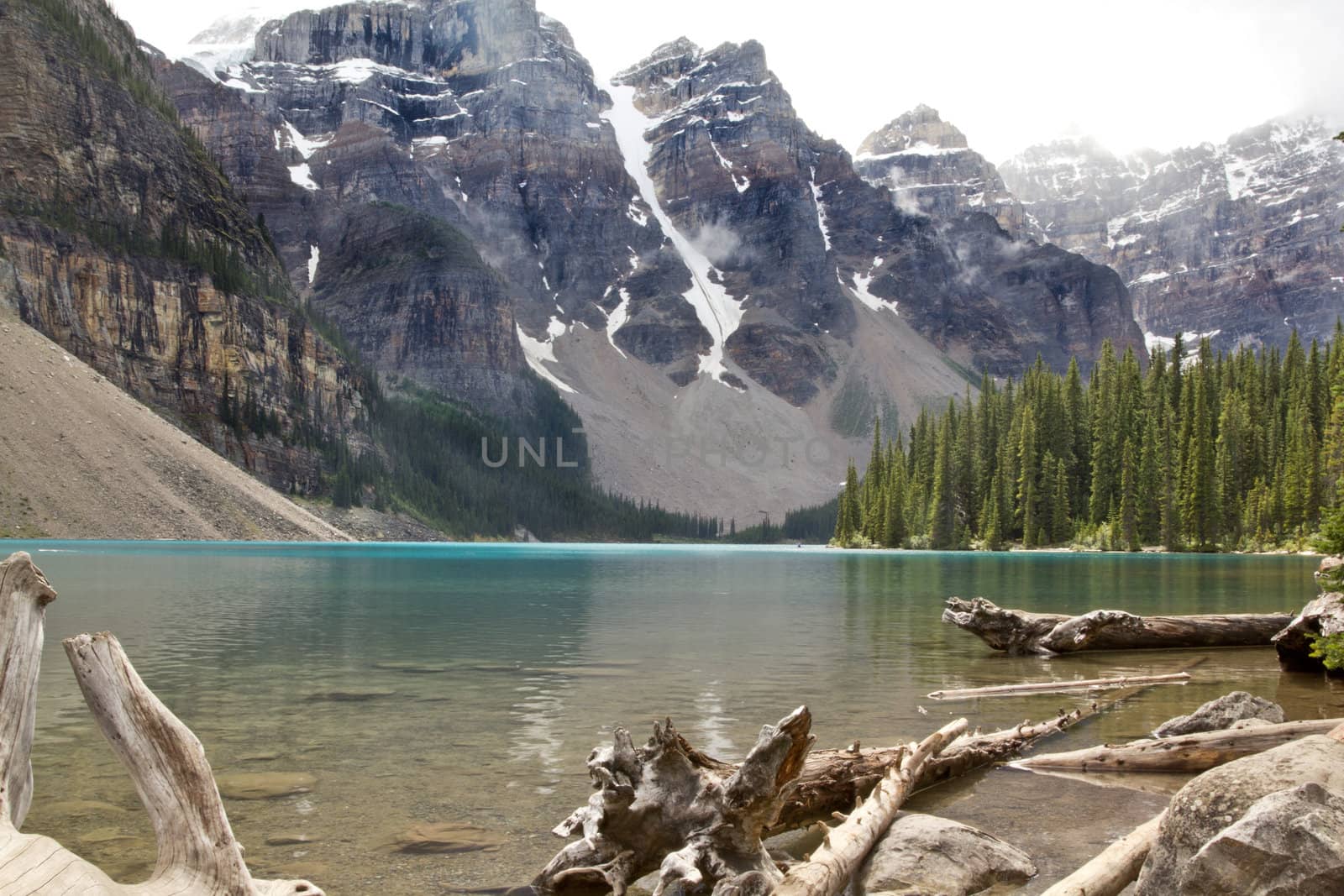 The beautiful turquoise colored Mourane Lake against the backdrop of the majestic mountains of the Canadian Rockies