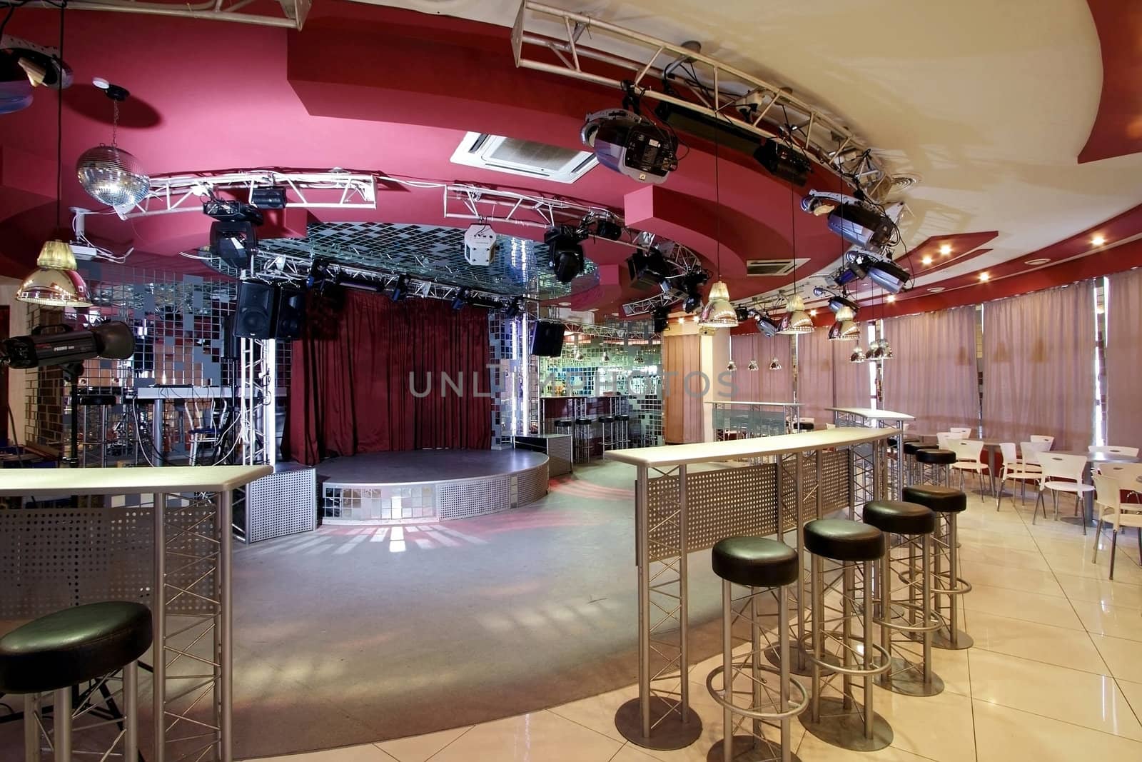 Interior of night club with a bar and a scene