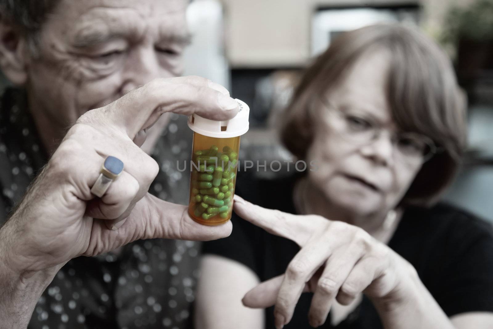 Senior couple at home with prescription bottle