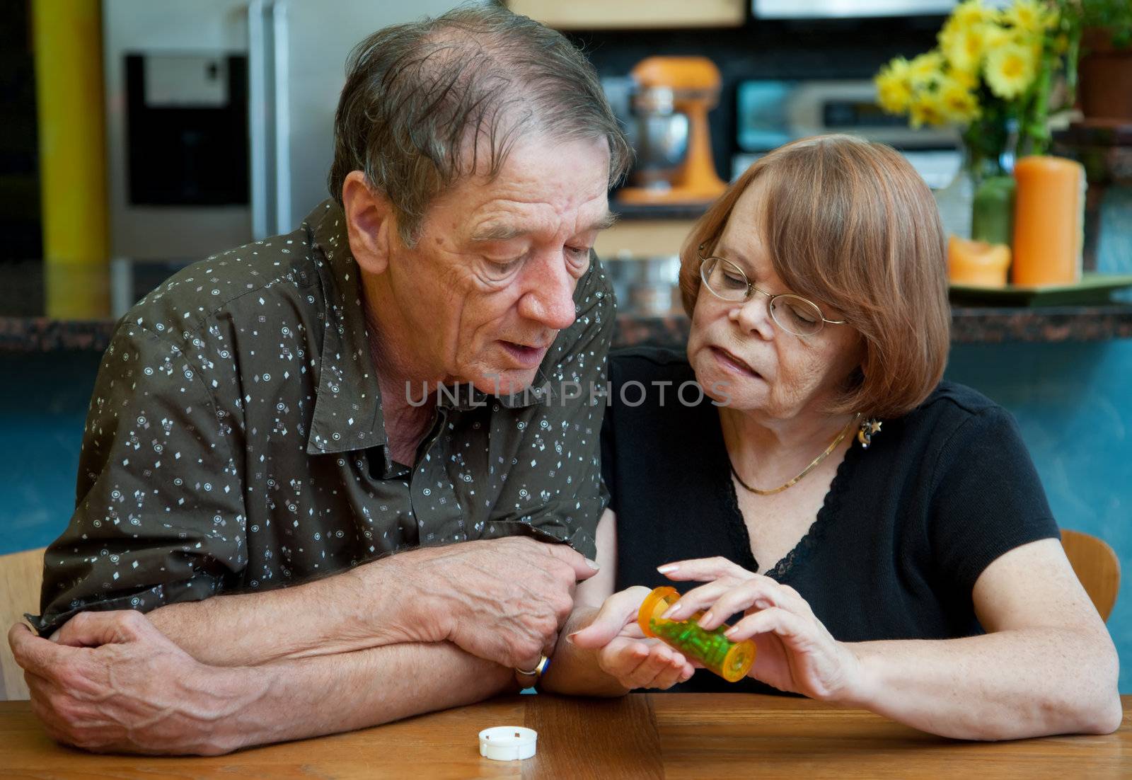 Senior Couple at Home in Kitchen Discussing Medication