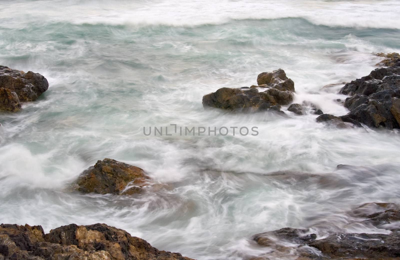 soft and vapour like water on rocks at the sea