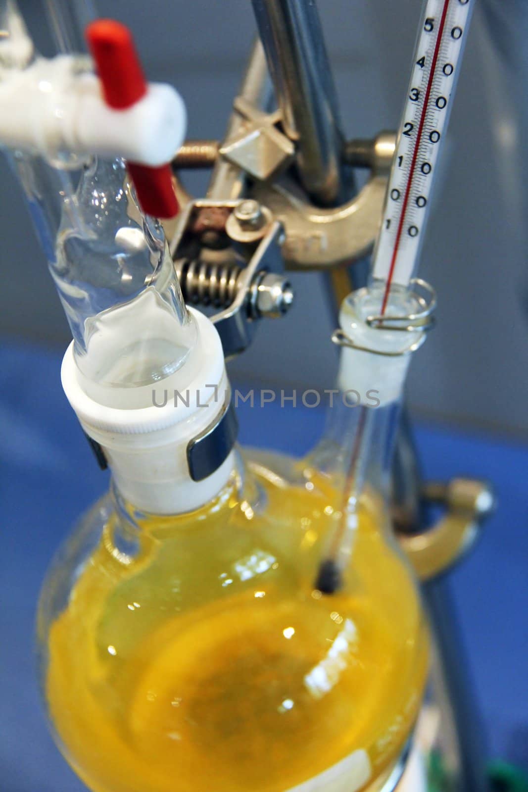 chemical laboratory with yellow liquid and bottles