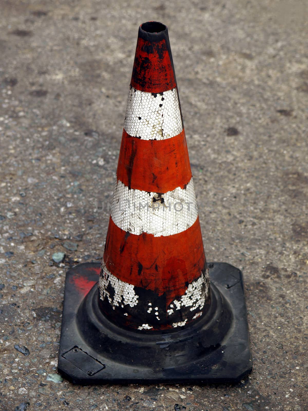 Traffic cone for road works with red and white stripes