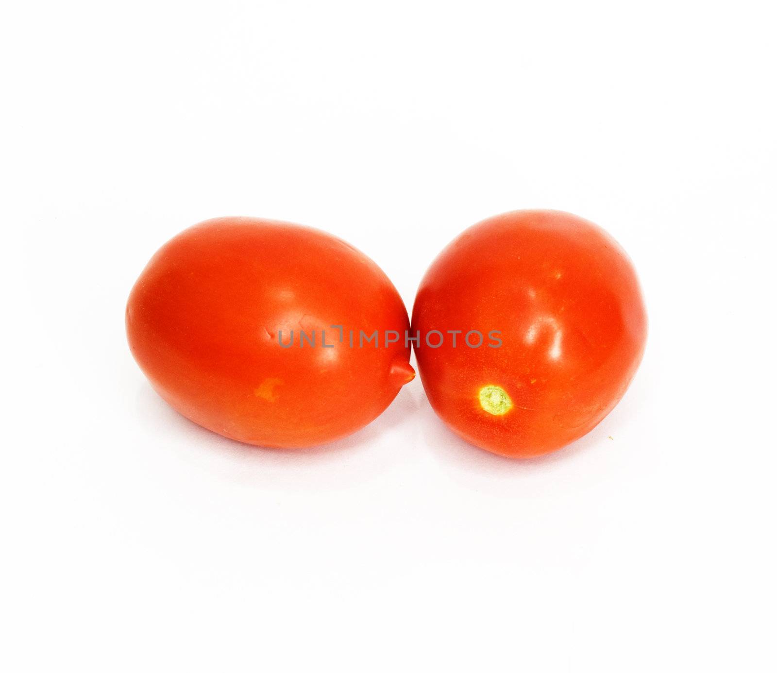 two tomatoes isolated on white  by schankz